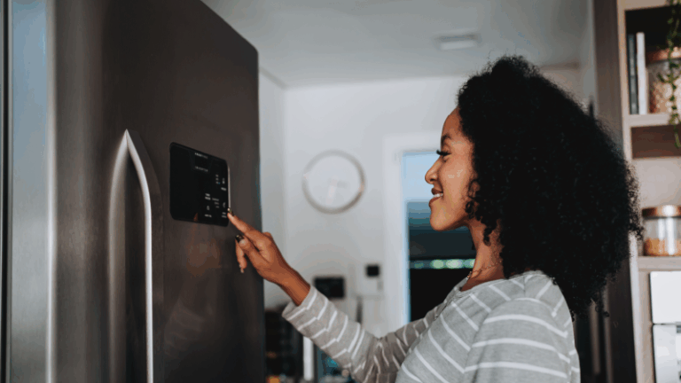 woman setting the temperature on a refrigerator